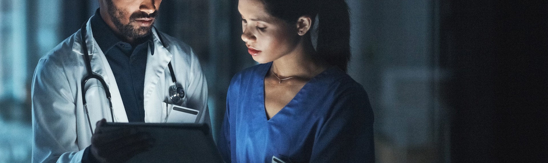 Image of doctor showing charts to nurse during night shift