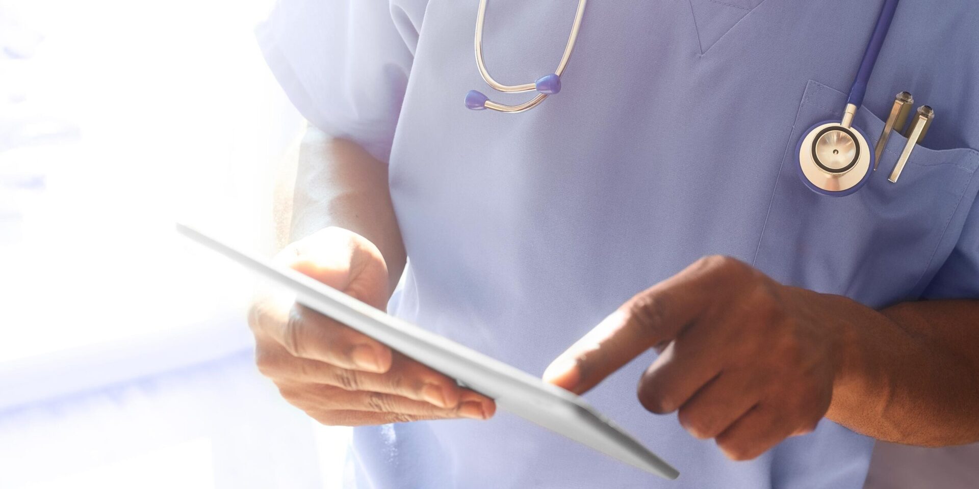 Closeup image of medical professional working on a tablet